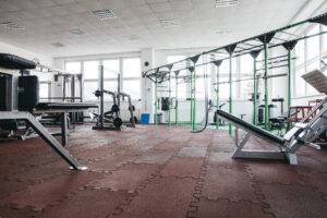 A gym front desk stocked with bottled water, protein bars, and clean towels, ready for members. The image conveys reliability, freshness, and convenience.